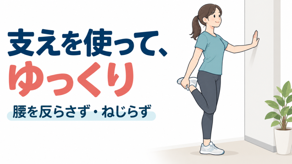 壁に手を添え、片膝を曲げて足首を支えながら太ももの前を伸ばす姿勢